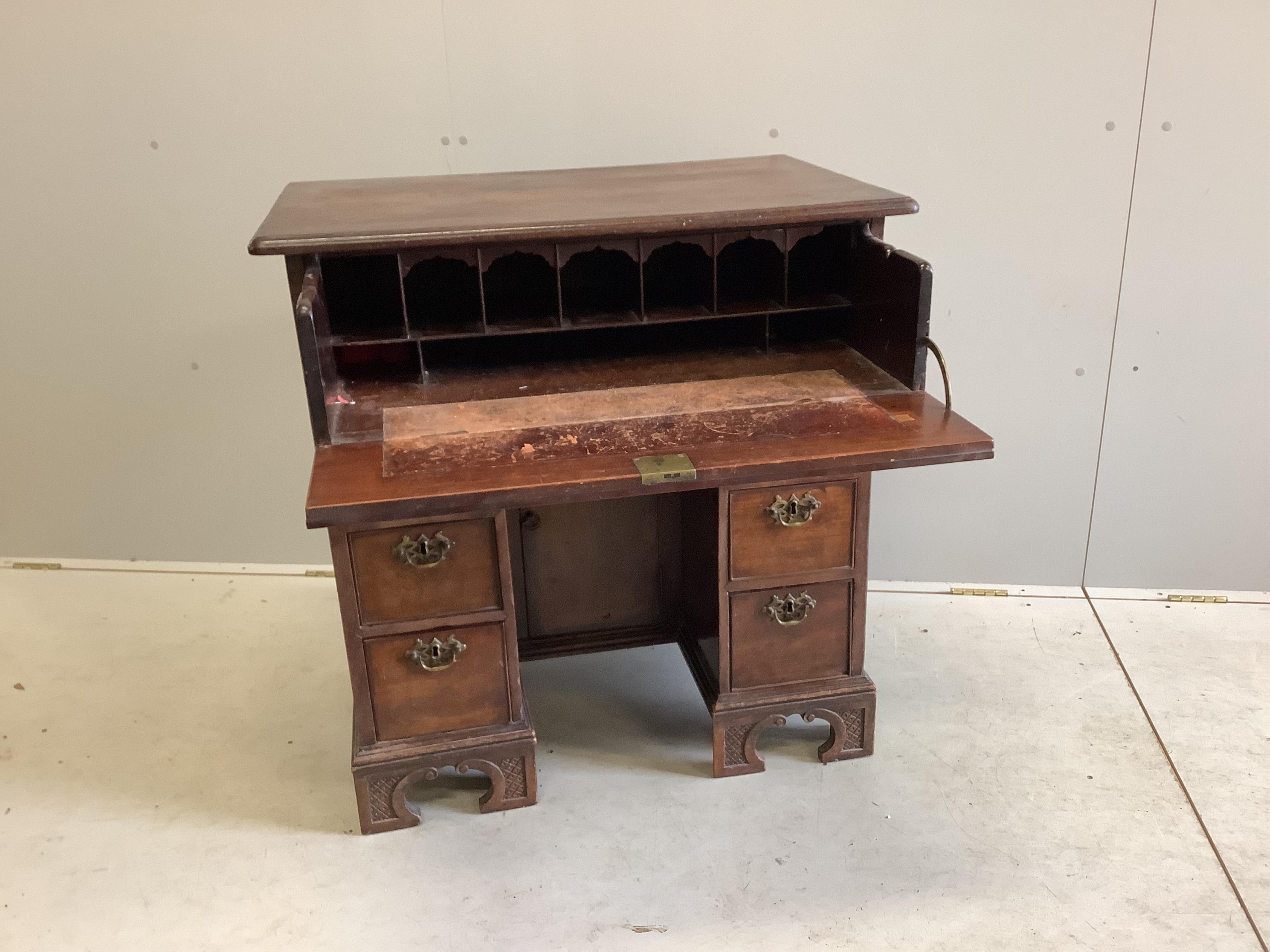 A George III mahogany kneehole desk with later secretaire drawer, width 84cm, depth 55cm, height 87cm. Condition - poor to fair